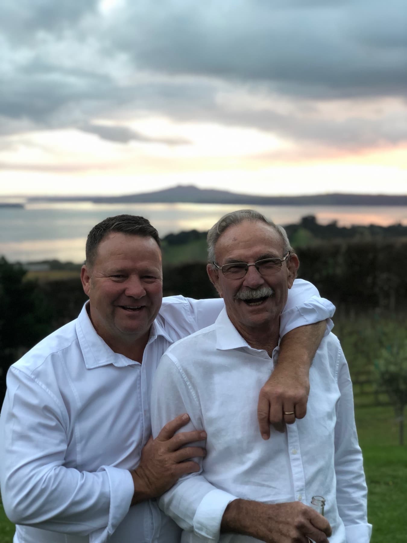 Finn Glengarry with his father Rob, Rangitoto behind them